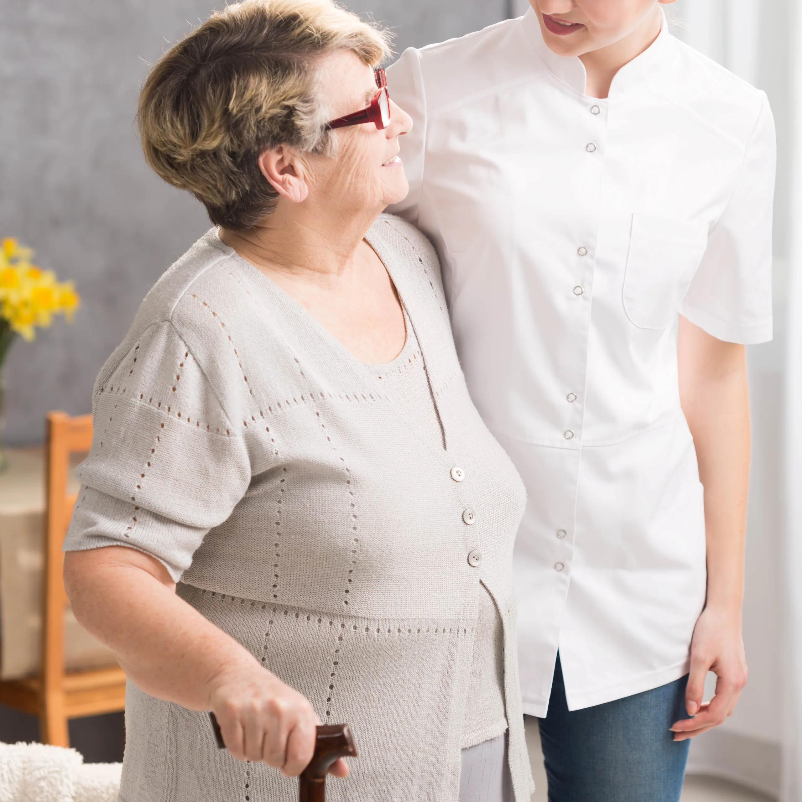 caregiver-and-elderly-woman-walking-2024-10-21-14-06-33-utc