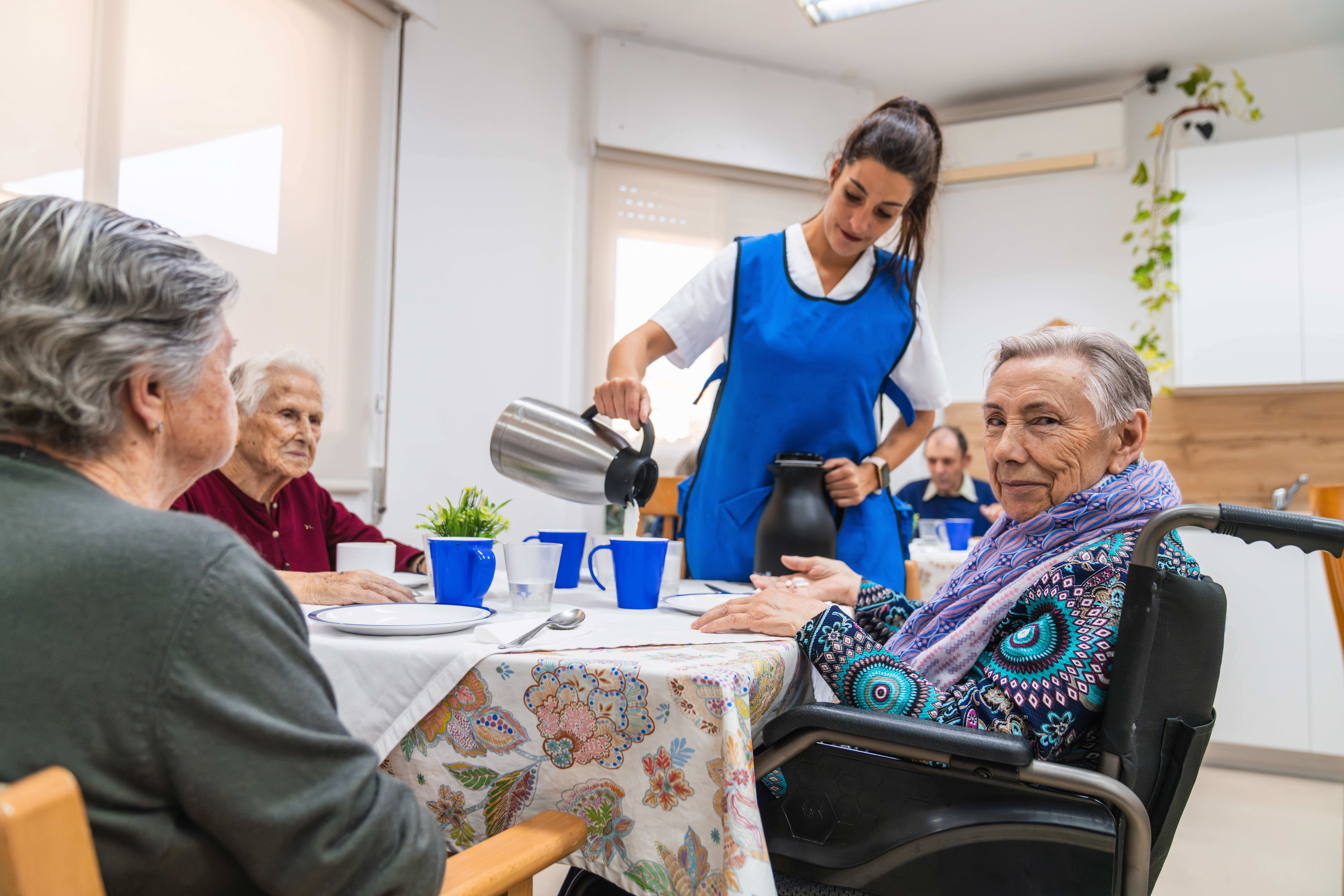 caring-nurse-assisting-elderly-in-nursing-home-2025-03-10-07-21-47-utc